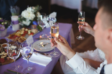 Hands holding glasses and toasting, happy festive moment, luxury