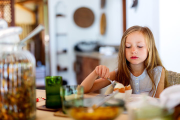 Canvas Print - Little girl eating breakfast