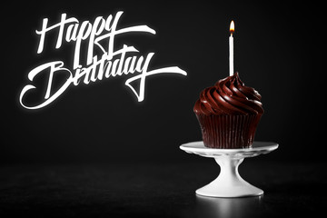 Wall Mural - Cupcake with candle and text HAPPY BIRTHDAY on black background