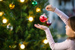 © ADDICTIVE STOCK - Little girl decorating Christmas Tree