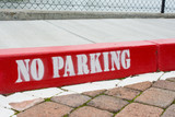 Fototapeta Desenie - Painted red curb with no parking 