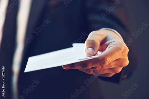 Fotografía Businessman offering cash money in envelope as bribe