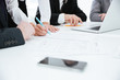 © Drobot Dean - Cropped image of business team by the table