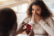 © Viacheslav Yakobchuk - Shocked African American woman getting the proposal from her boyfriend