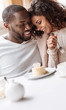 © Viacheslav Yakobchuk - Careful African American couple enjoying the dessert in the cafe