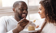 © Viacheslav Yakobchuk - Funny African American couple enjoying the dessert in the cafe