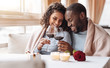 © Viacheslav Yakobchuk - Joyful African American couple drinking wine in the restaurant