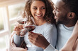 © Viacheslav Yakobchuk - Positive African American couple holding wineglasses in the restaurant