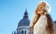 woman looking into the distance while wearing Venetian mask
