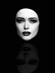 monochrome art fashion portrait of beautiful woman face like a mask. female head