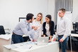 © romankosolapov - Group Young Coworkers Making Great Business Decisions.Creative Team Discussion Corporate Work Concept Modern Office.Startup Marketing Idea Presentation.