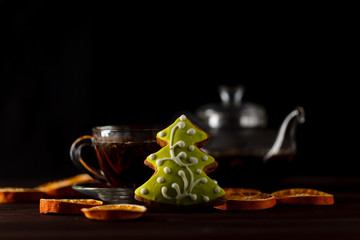 Transparent teacup with black tea in low key