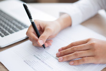 Closeup Of Business Person Completing Form