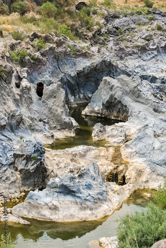 Fotografie, Obraz The river Simeto across an ancient lava flow near Adrano