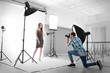 © Africa Studio - Photographer taking picture of  model in studio