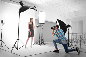 Photographer taking picture of  model in studio