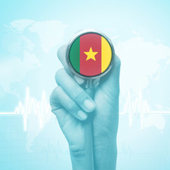 hand holding stethoscope with Cameroon flag.