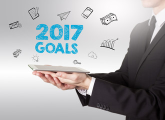 Wall Mural - 2017 goals concept, young man holding a tablet computer