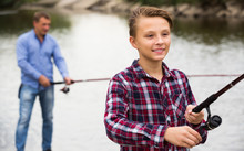Portrait Of Boy Casting Line For Fishing