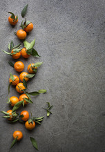 Fresh Tangerines With Green Leaves On Grey Background