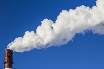 smoking chimneys against blue sky