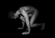© Connect Images - Nude muscular man crouching