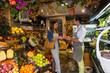 © Connect Images - Fruiterer serving customer in shop, Palma de Mallorca, Spain