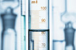 © Connect Images - Meniscus. Curved surface (meniscus) of water in graduated cylinder. Liquid volume measured by reading the scale at the bottom of the meniscus. The reading is 82.6 mL