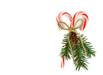 Christmas candy canes and pine bouquet with twine bow isolated on white