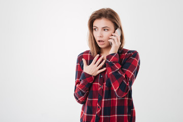 Poster - Portrait of a shocked young girl talking on mobiel phone