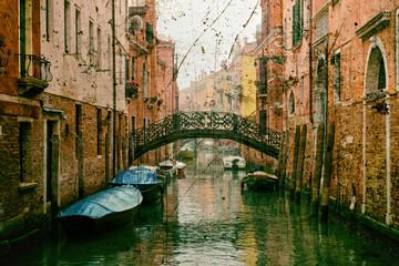 Typical Venice canal with moored boats with a vintage effect