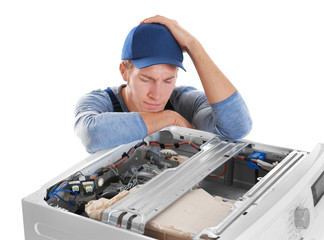 Wall Mural - Plumber with washing machine on white background