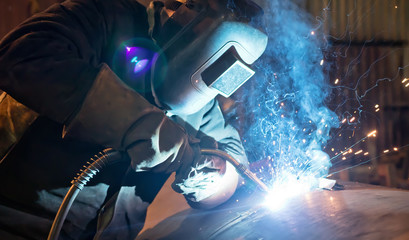 Canvas Print - Semi-automatic welding with sparks and smoke