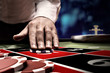 gambler bet on roulette at casino table