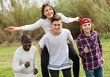 © JackF - Portrait of laughing friends running on field