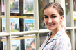 © highwaystarz - Portrait Of Young Woman Looking In Window Of Estate Agent