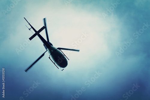 Fotomural Helicopter flying in the blue sky