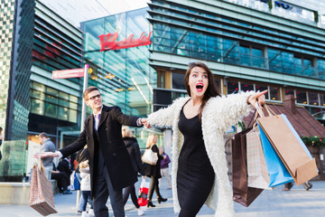 Couple with a shopping bags having an argument outdoors