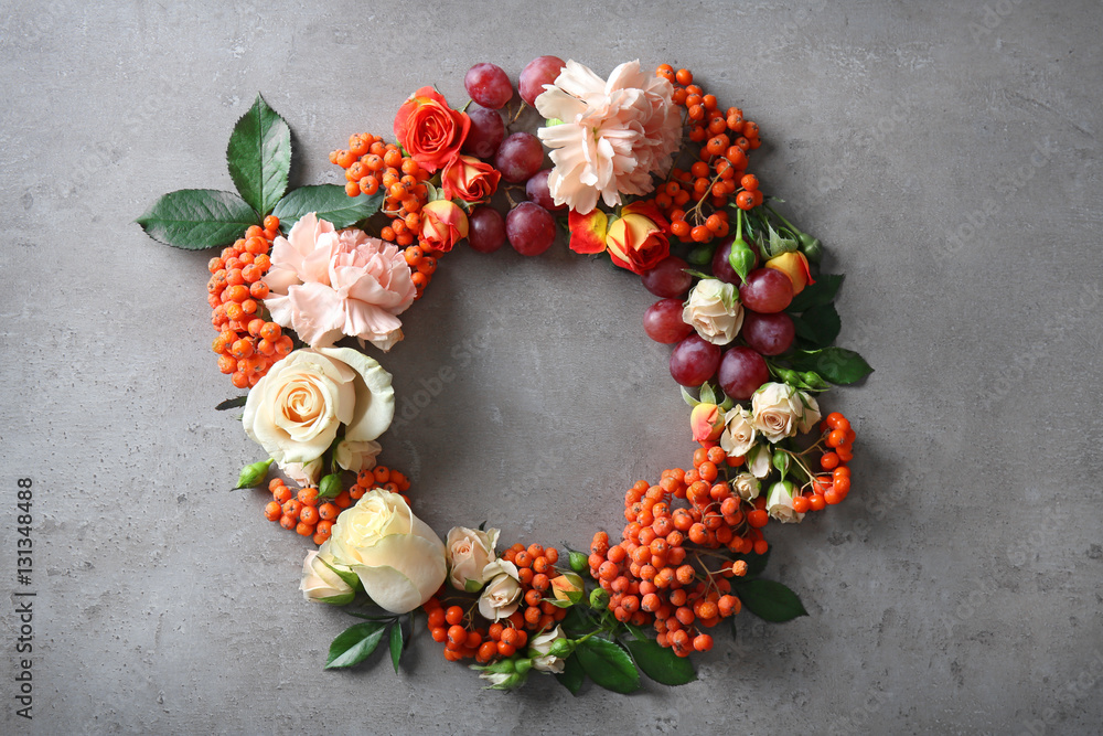 Beautiful flowers wreath on grey textured background