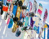 several snowboards are about fencing
