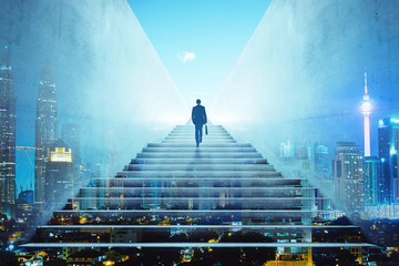 rear view of a businessman climbing stairs to get to a large city center. concept of success and app