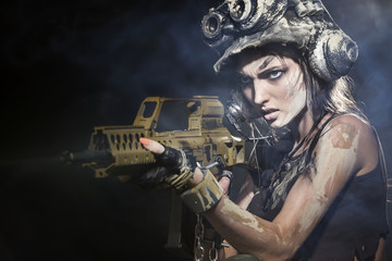 The girl - a soldier, in an unusual helmet, firing a machine gun