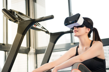 Wall Mural - beauty asian woman rest on treadmill with VR headset