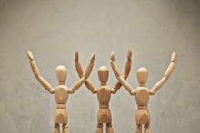 Three Wooden Mannequin Hands Up As Winners