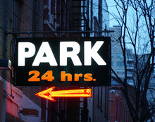 24 Hour Parking Garage Sign In Neon Colors In Manhattan Village New York City. Expensive Rates To Park Cars And Vehicles Any Time Of Day