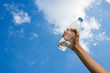 © Songwut Pinyo - Handle water bottle on blue sky background