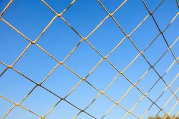 Football net on blue sky background