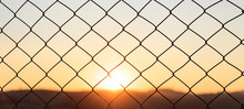 Wire Mesh Fence On A Sunset Background