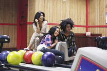 Young Women Together Hanging Out At Bowling Alley