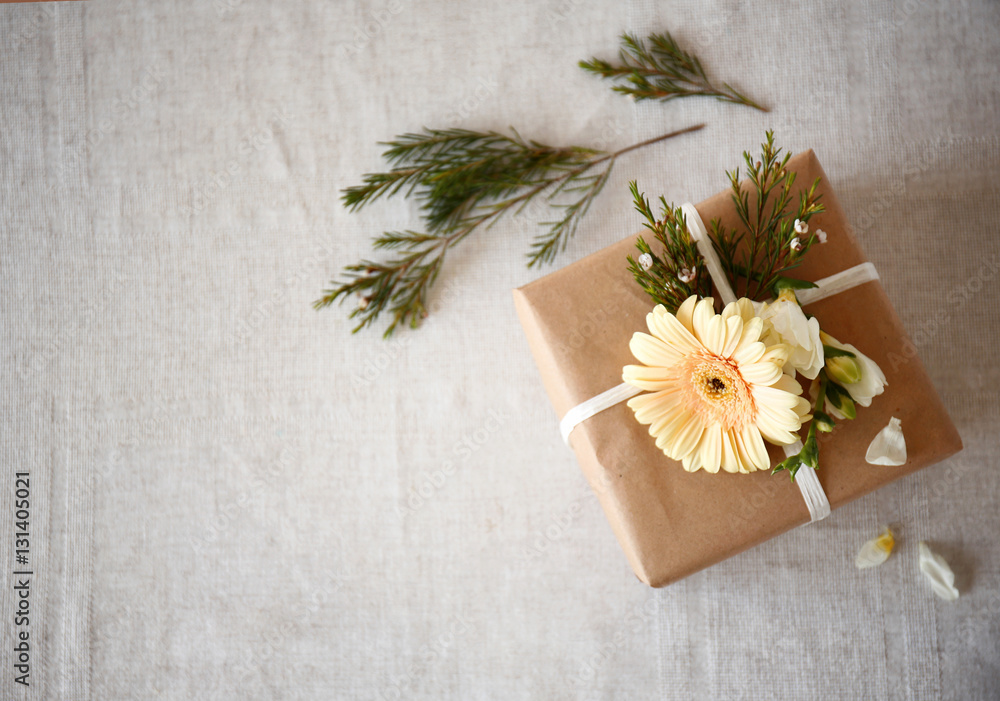 Handcrafted gift box with flowers on table